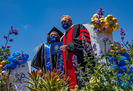 Dr. Walthers handing out diplomas at commencement.